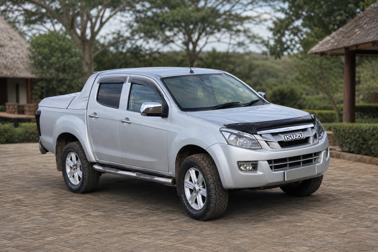 Silver Isuzu D-Max double-cab pickup in a professional outdoor product photograph