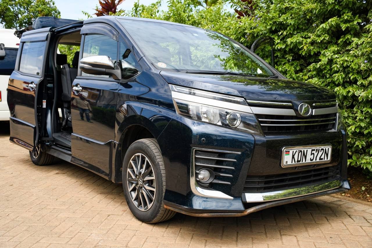 Black Toyota Voxy photographed from the front with a sliding door open